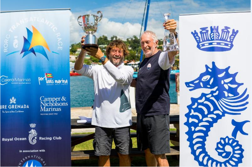 Giovanni Soldini, holds the Multihull Line Honours Trophy and Peter Cunningham the MOCRA Class winners decanter at a prizegiving held at Port Louis Marina, Grenada
