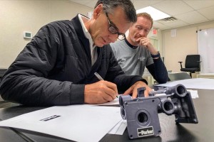 Craig Maxwell (at left), Vice President and Chief Technology and Innovation Officer for Parker Hannifin and Dimitri Despierres of American Magic's Design Team working at the team's production facility in Bristol, Rhode Island.