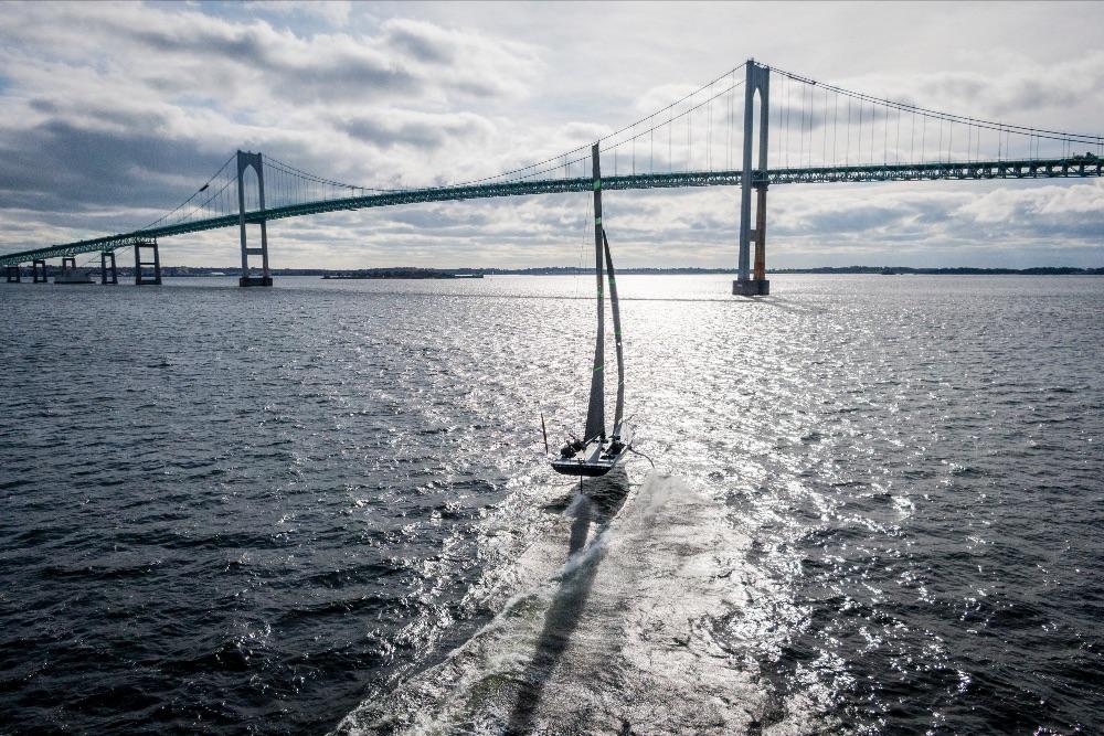 The Mule, American Magic's 38-foot test boat, flies on its foils near Rhode Island's Claiborne Pell Newport Bridge