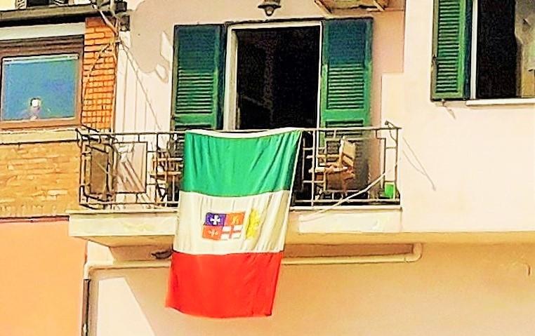 La bandiera navale italiana  esposta al balcone della sede di Artemare Club a Porto Santo Stefano per la Festa del Tricolore
