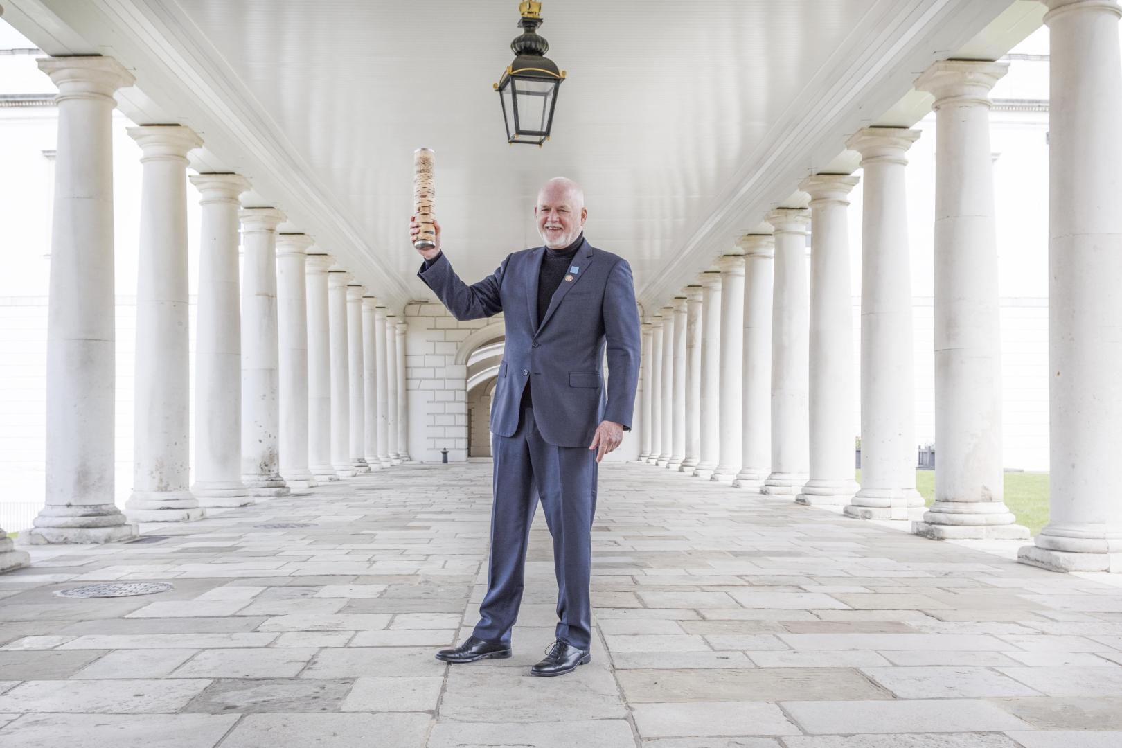 Ambassador Peter Thomson UN Secretary Generals Special Envoy for the Ocean holds aloft the Relay4Nature baton after receiving it at the National Maritime Museum in Greenwich London.