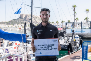 Olly Young from Mirpuri Foundation Racing Team with the UN Sports for Climate Action sign