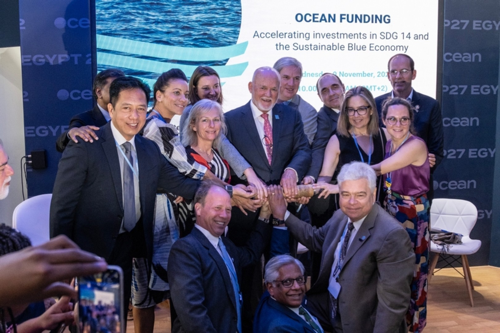 Founding members of the first-ever Ocean Pavilion at COP27 hold the Nature's Baton, which connects the world´s key environmental events